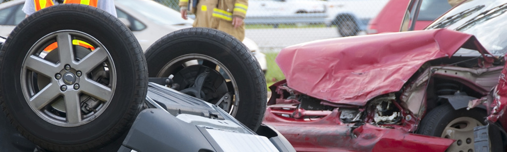 Rollover Vehicle Accident at Busy Intersection With Emergency Personnel